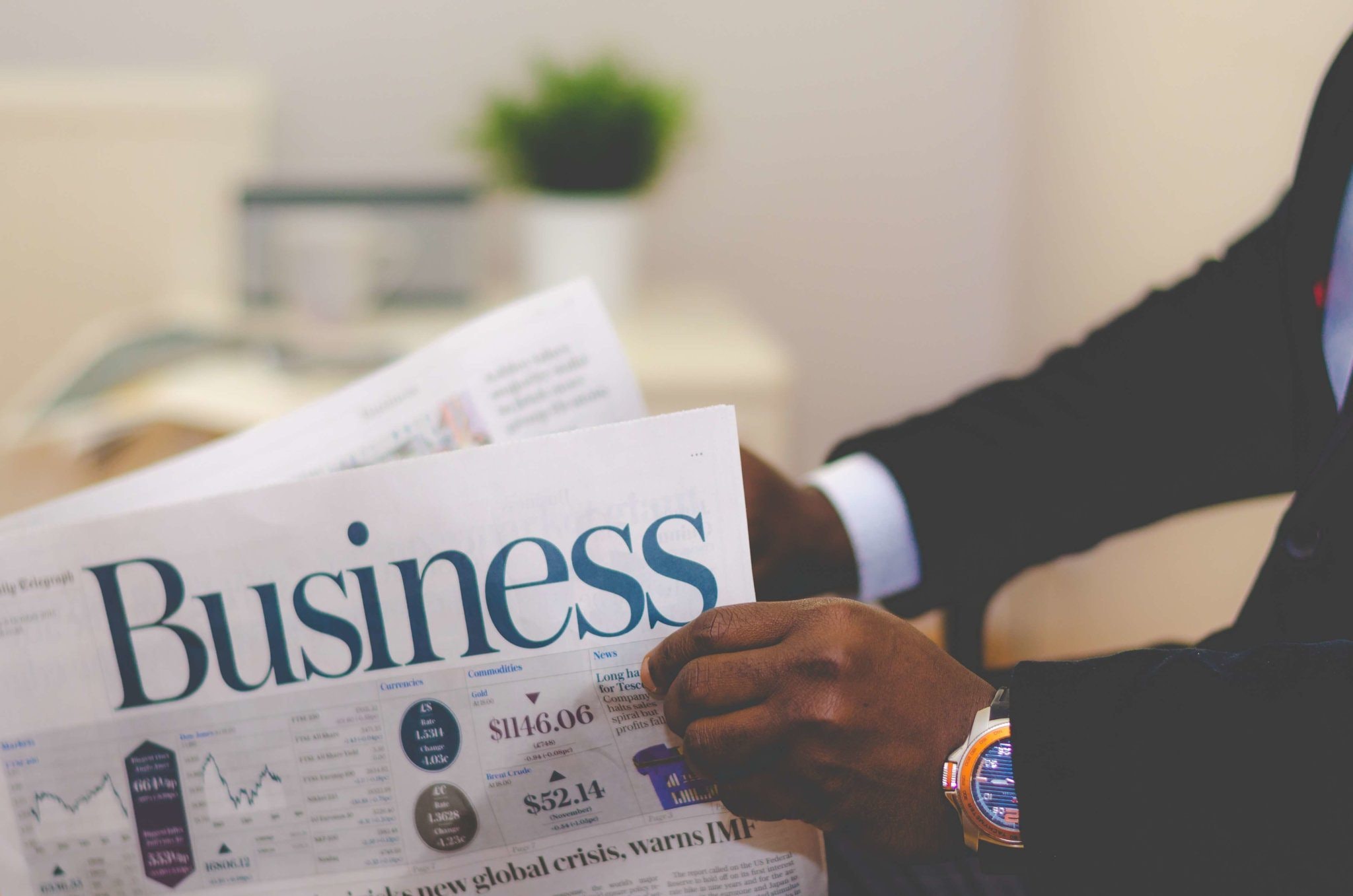person-holding-white-and-blue-business-paper-936137